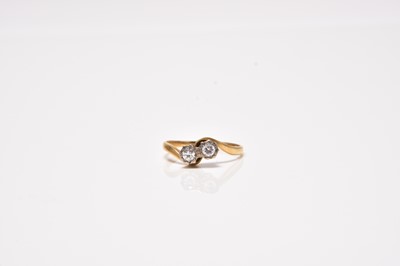 Lot 74 - An 18ct gold two stone diamond crossover ring