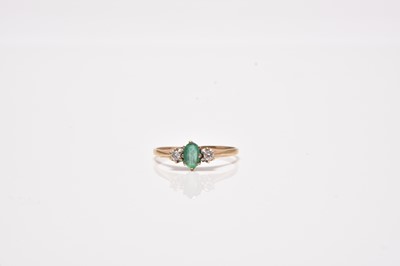 Lot 40 - A 9ct gold three stone emerald and diamond ring