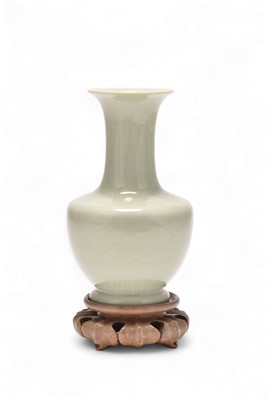 Lot 10 - A Chinese celadon glazed carved bottle vase