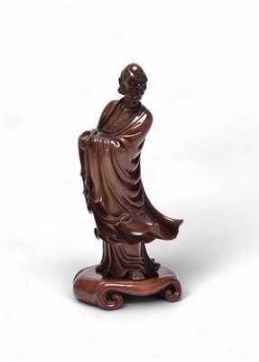 Lot 58 - A Chinese carved hardwood figure of an immortal or scholar