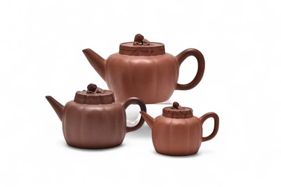 Lot 40 - A group of three Chinese Yixing stoneware 'lion' teapots and covers