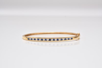 Lot 239 - A sapphire and diamond hinged bangle