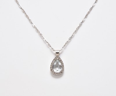 Lot 321 - An aquamarine and diamond pendant on chain