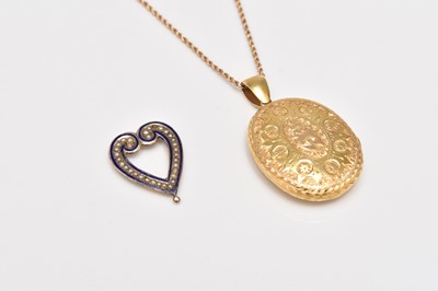 Lot 334 - A yellow metal bright cut engraved oval locket