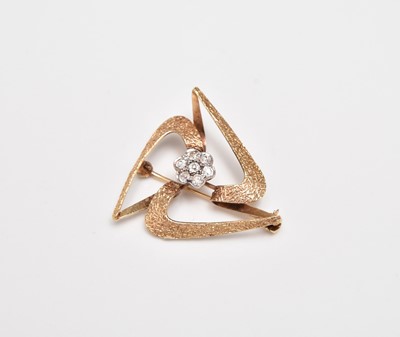 Lot 414 - A 9ct gold diamond set abstract brooch