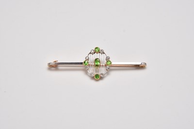 Lot 292 - An early 20th century demantoid garnet and diamond bar brooch
