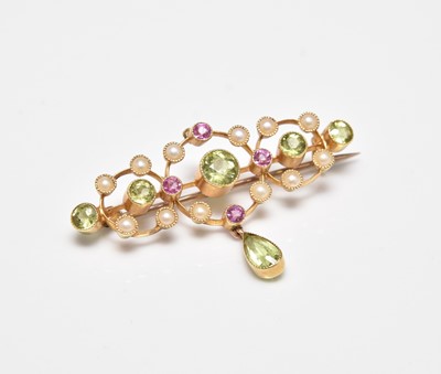 Lot 247 - An early 20th century peridot, seed pearl and pink tourmaline bar brooch