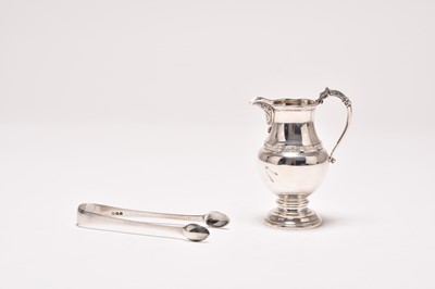 Lot 38 - A silver cream jug and pair of silver sugar tongs