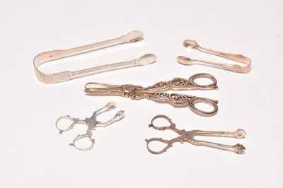 Lot 163 - A pair of silver grape scissors, two pairs of sugar tongs and a pair of tea tongs