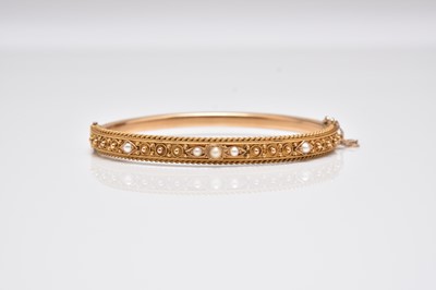 Lot 288 - A 15ct gold seed pearl hinged bangle