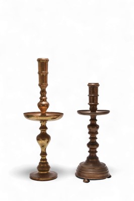 Lot 114 - A large Indian brass candlestick, 19th century, and another later example
