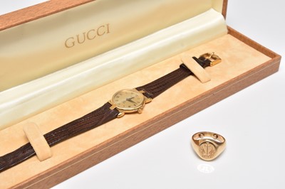 Lot 266 - A yellow metal signet ring and a Gucci quartz wristwatch