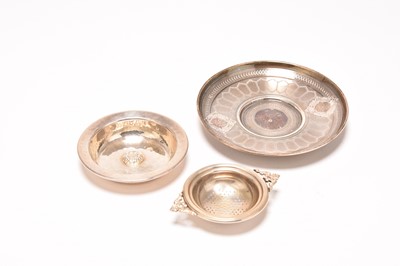 Lot 168 - A French silver saucer, a silver tea strainer and a white metal dish
