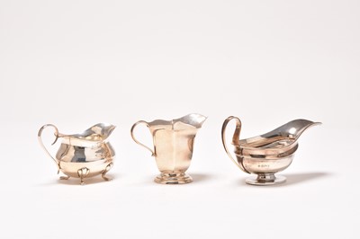 Lot 4 - Two silver cream jugs and a silver sauce boat