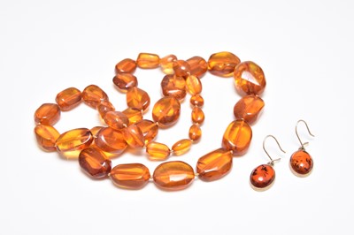 Lot 400 - A pair of amber earrings and an amber necklace
