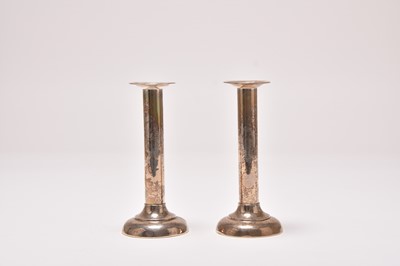 Lot 21 - A pair of white metal mounted candlesticks