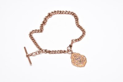 Lot 377 - A 9ct rose gold graduated curb link albert