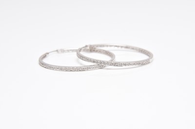 Lot 238 - A pair of diamond set hoop earrings