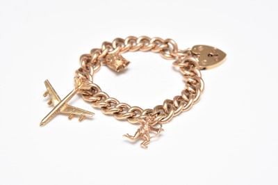 Lot 350 - A 9ct gold curb link bracelet with attached charms