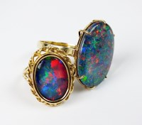 Lot 45 - An oval opal triplet dress ring, the...