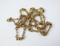 Lot 56 - A yellow metal decorative chain and bead...