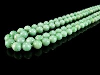 Lot 91 - A double strand jade bead necklace, comprising...