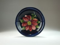 Lot 124 - A shallow Moorcroft pottery dish in the...