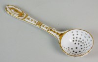 Lot 276 - A French porcelain sugar sifter spoon,...