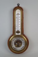Lot 383 - An brass cased aneroid barometer the 7¼ inch...
