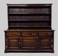 Lot 411 - A George III oak high dresser, the boarded...