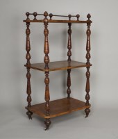 Lot 460 - A late Victorian walnut three tier what-not,...