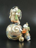 Lot 115 - A Japanese Kutani moriage figural group, 20th...