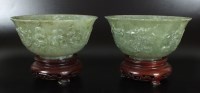 Lot 175 - A pair of mottled spinach jadeite bowls, 20th...