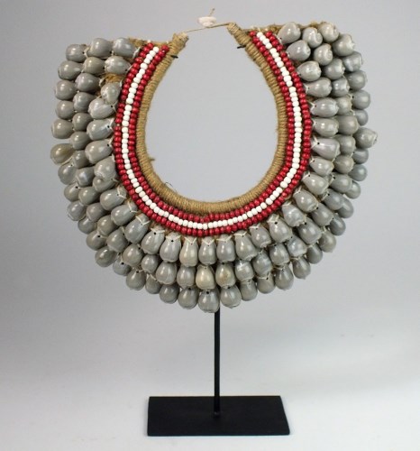 Lot 53 - A woven seed & shell necklace on stand from...