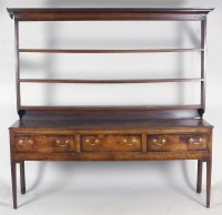 Lot 209 - A George III oak high dresser, the three shelf...