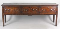 Lot 216 - A George III oak three drawer dresser base,...