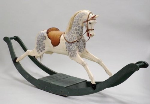 Lot 149 - A large dapple grey rocking horse with tan...