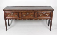 Lot 224 - A mid 18th century oak three drawer dresser...