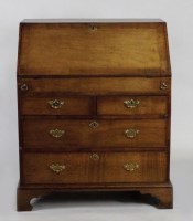 Lot 230 - A mid 18th century oak crossbanded bureau the...