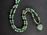 Lot 135 - A Chinese jade bead pendant and yellow metal...