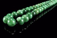 Lot 144 - A large jade bead necklace, the continuous...
