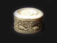 Lot 181 - A Canton carved ivory reticulated box and...