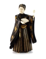 Lot 236 - A Japanese ivory and carved hardwood okimono...