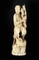 Lot 240 - A Japanese ivory okimono of a farmer, Meiji...