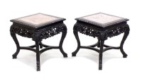 Lot 299 - A pair of Chinese carved hardwood urn stands,...