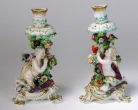 Lot 66 - A pair of Derby candlesticks depicting Cupid,...