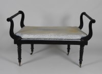 Lot 221 - A late 19th century ebonised window seat, the...