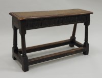 Lot 275 - A 17th century style joined oak bench, the...