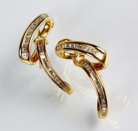Lot 148 - A pair of stylised diamond set earrings, each...