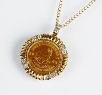 Lot 158 - A 1/10 Krugerrand coin pendant, within diamond...